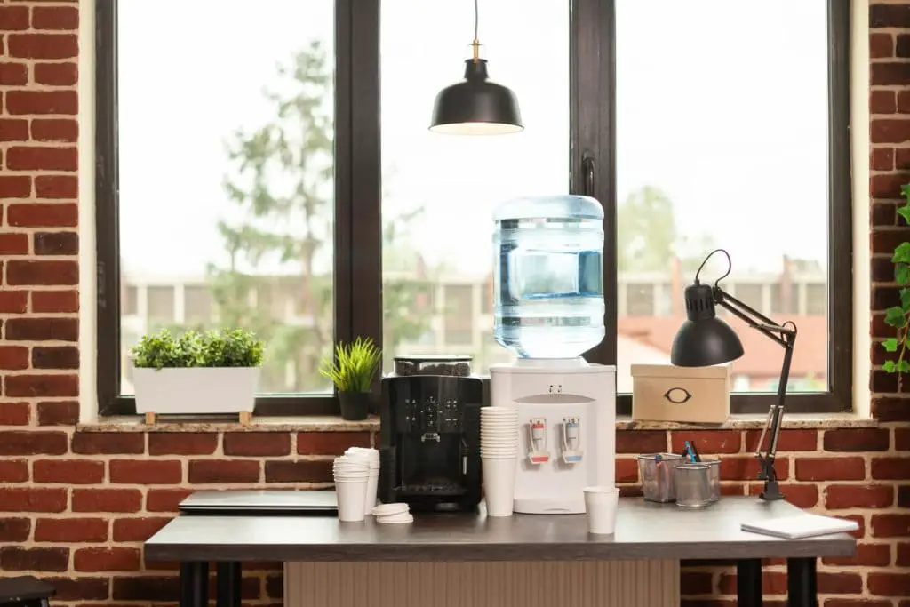 water dispenser and coffee machine on table in meeting office