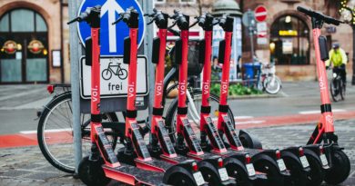 Electric scooters locked to bike rack